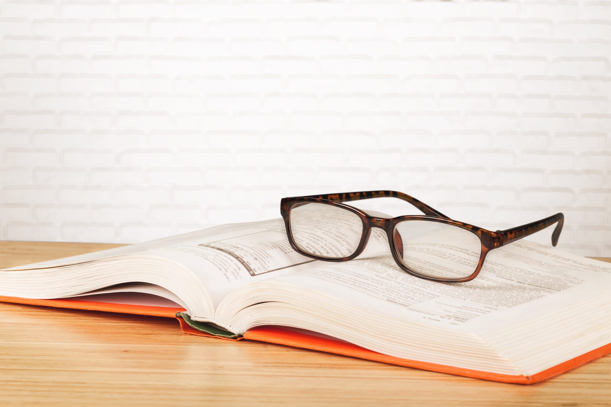 Glasses on open book. Reading on paper for health.