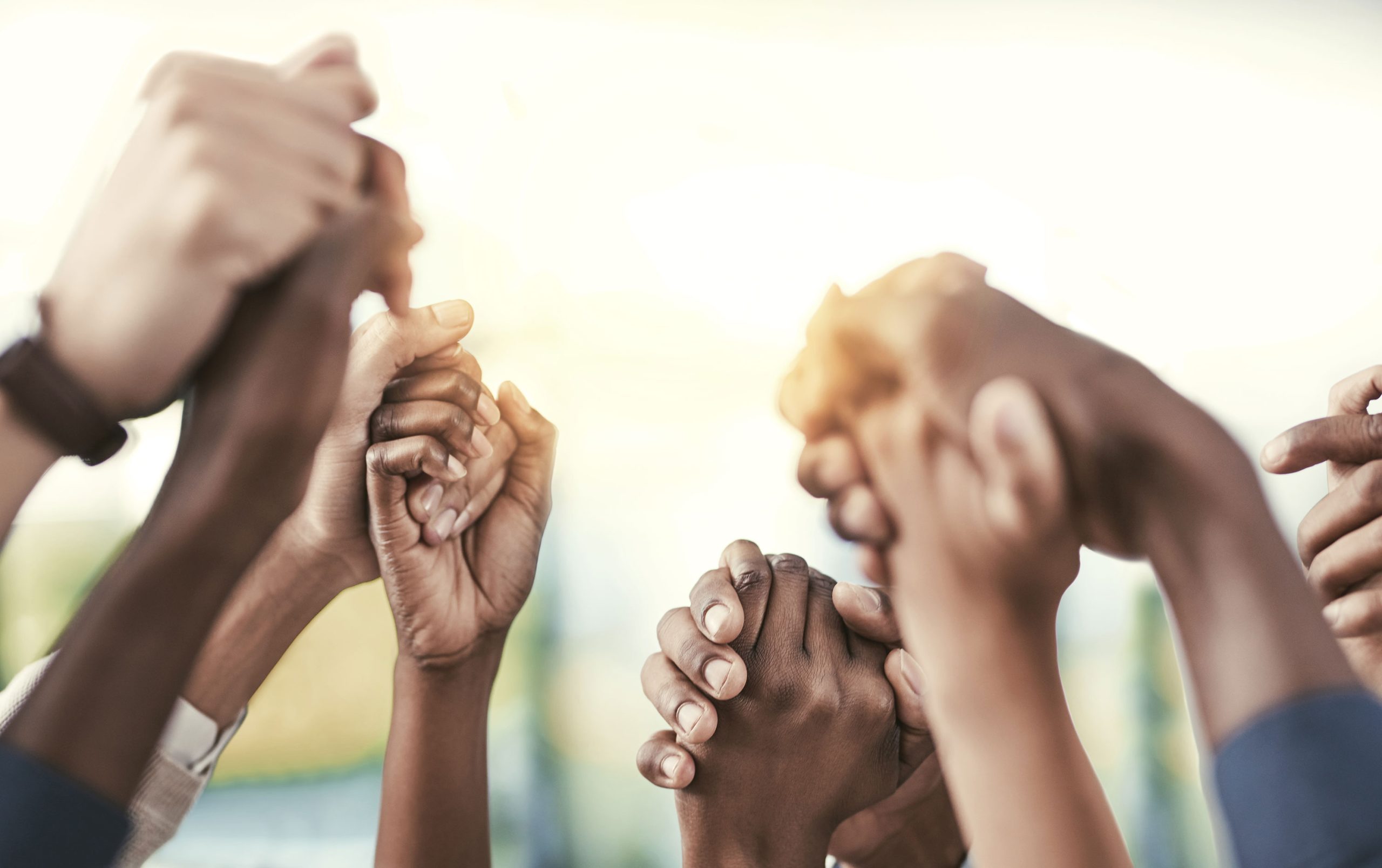 Diverse hands joined together, symbolizing unity and teamwork, relevant to a certified minority business enterprise.