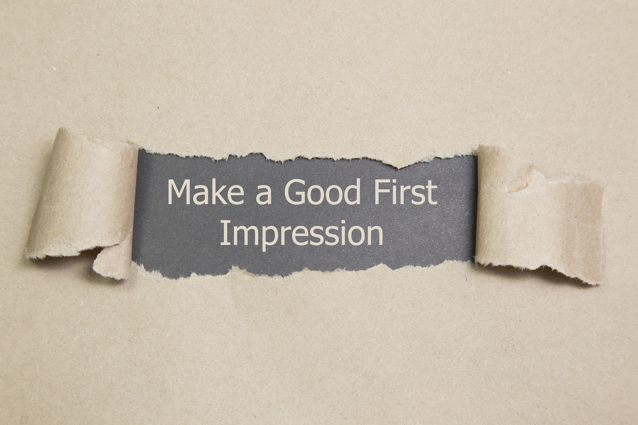 Torn paper revealing text: "Make a Good First Impression
