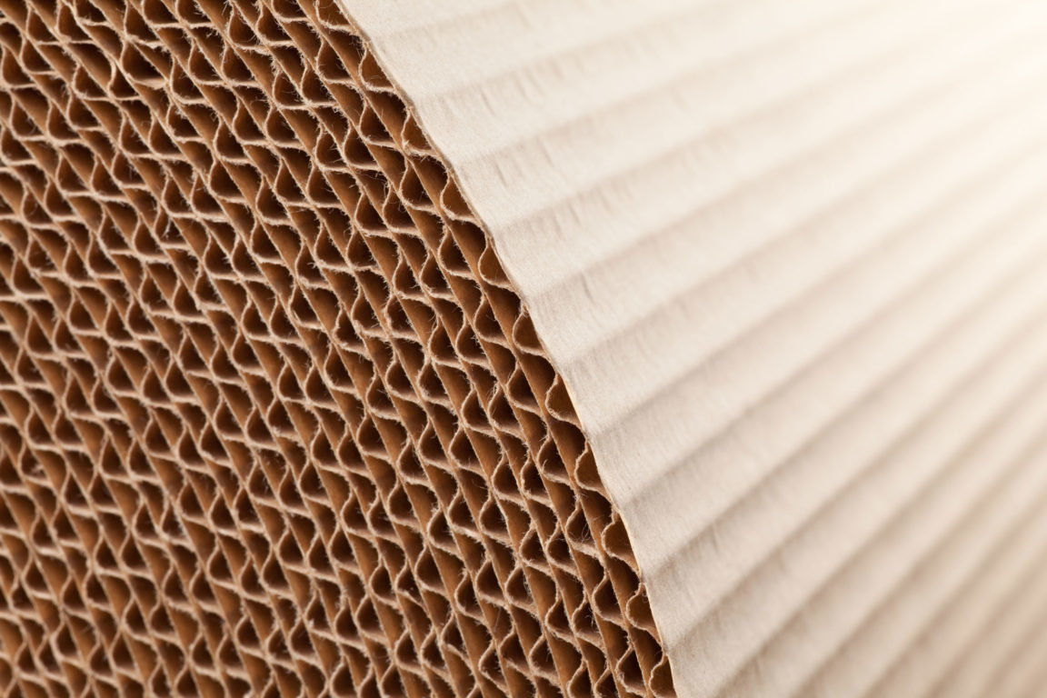 Close-up of corrugated cardboard layers showing the fluted inner structure.