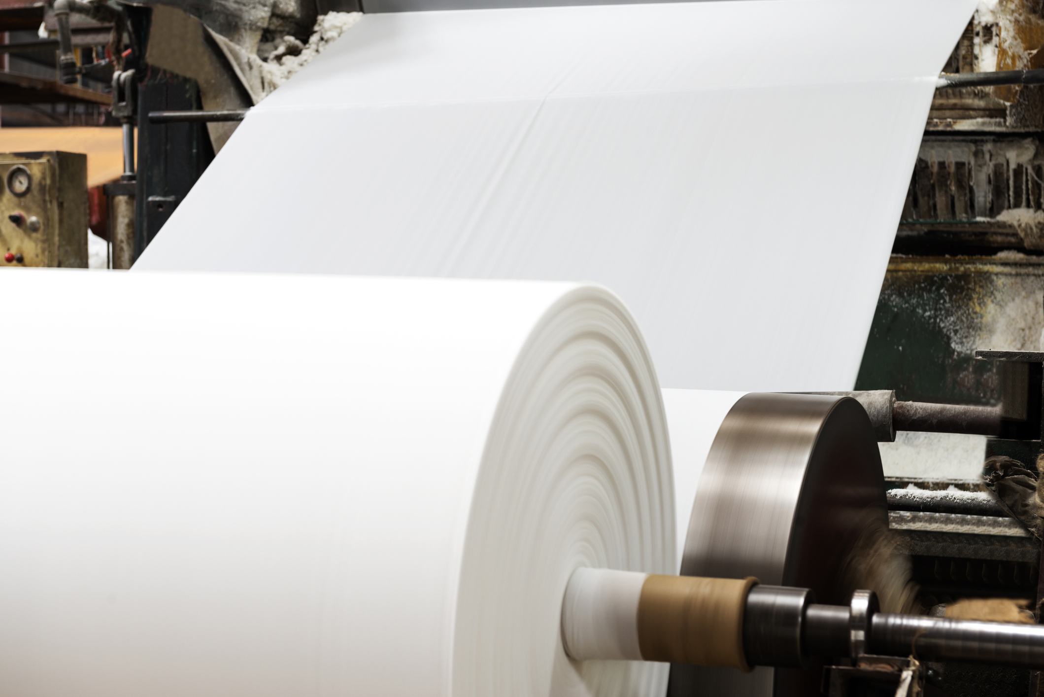Roll of paper being produced in a sustainable paper production factory.