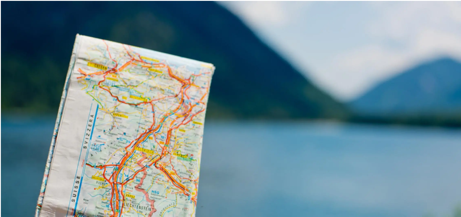Paper road map of Switzerland, Liechtenstein, and Austria for a screen-free summer road trip.